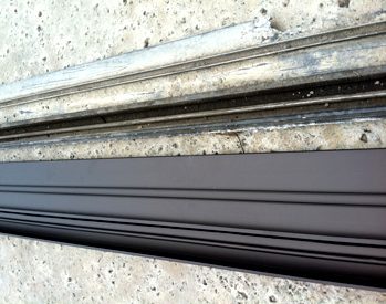Example of sliding door track repair: new and old tracks